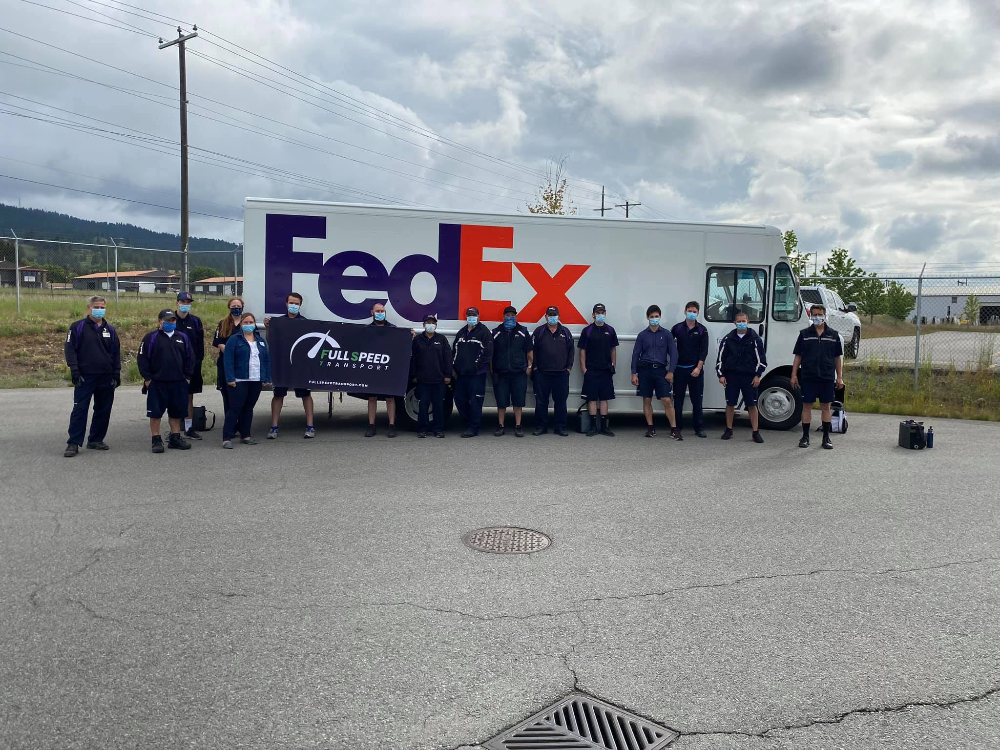 The Full Speed Transport team in front of a FedEx Ground truck